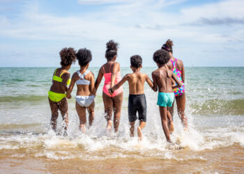 kids running into the ocean