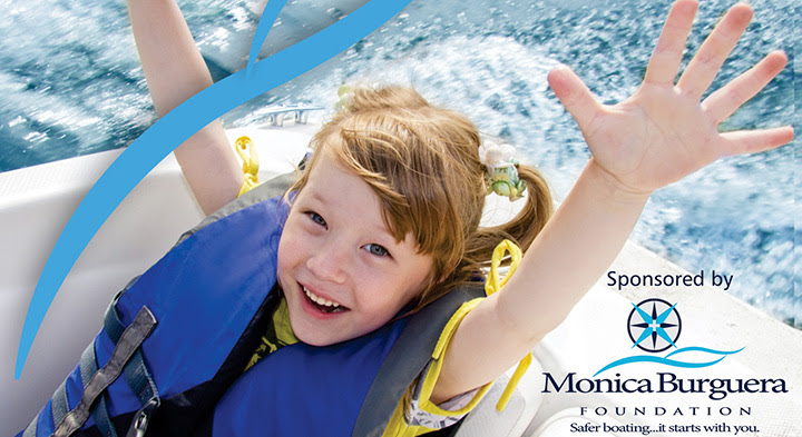 Child smiling wearing life jacket on boat